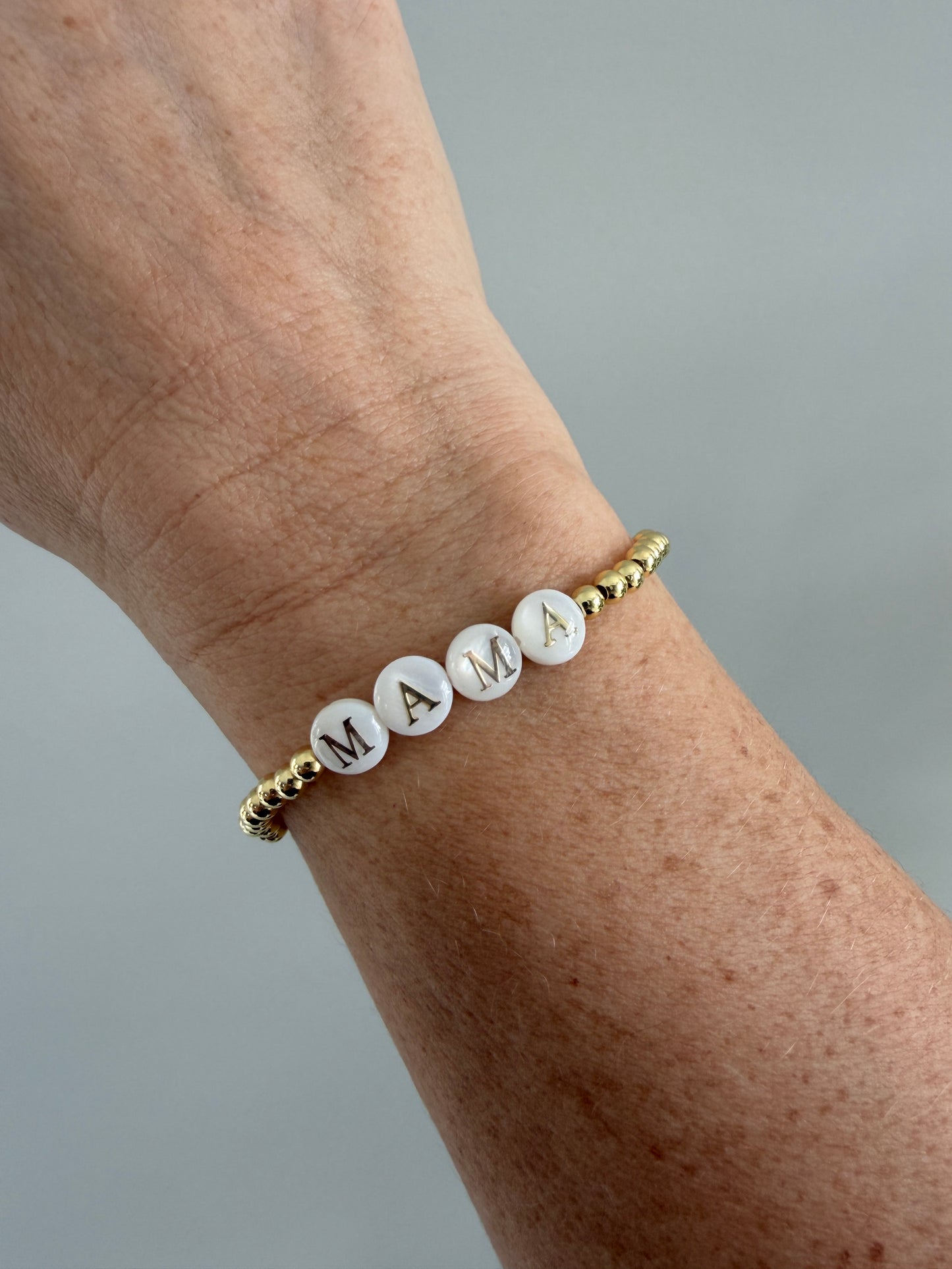 18k Gold-filled mama bracelet stacked with minimalist gold bracelets