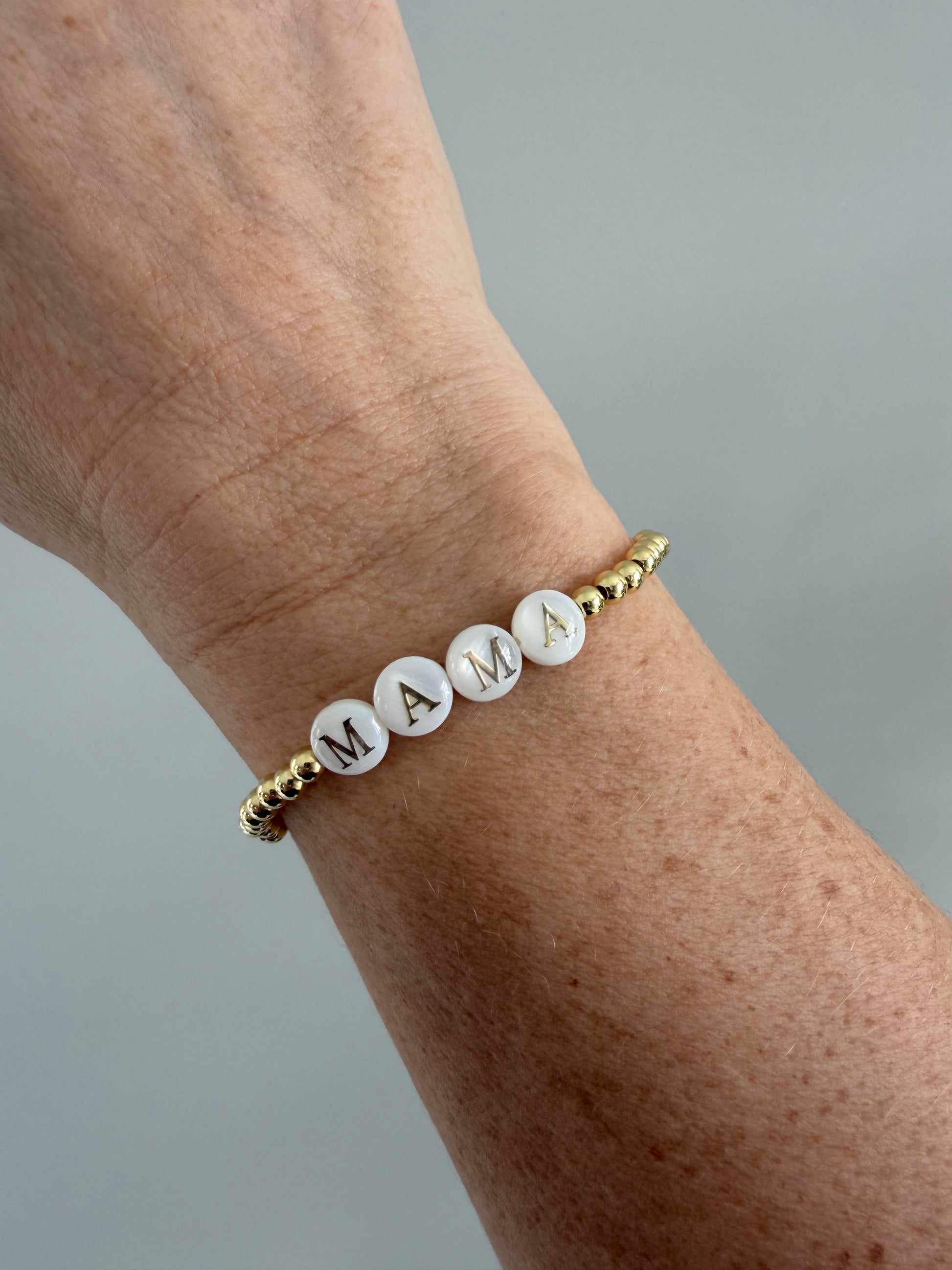 18k Gold-filled mama bracelet stacked with minimalist gold bracelets