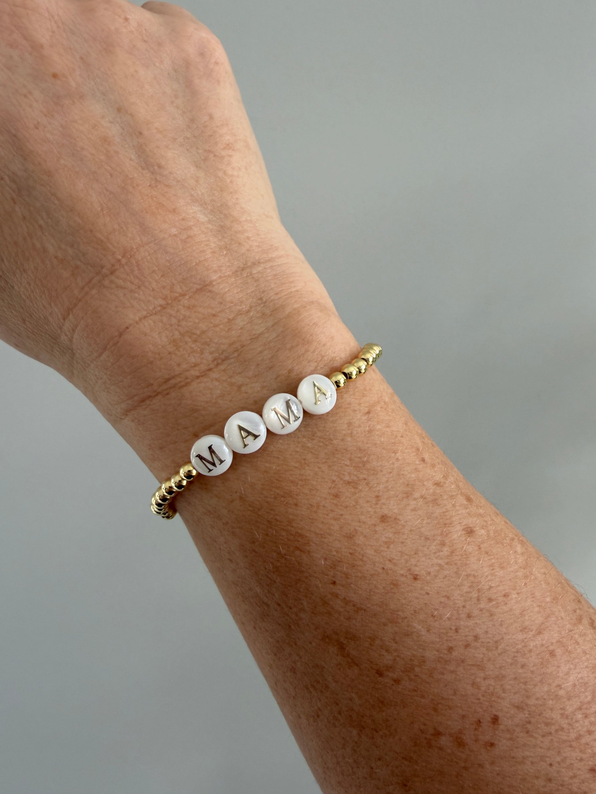 18k Gold-filled mama bracelet stacked with minimalist gold bracelets
