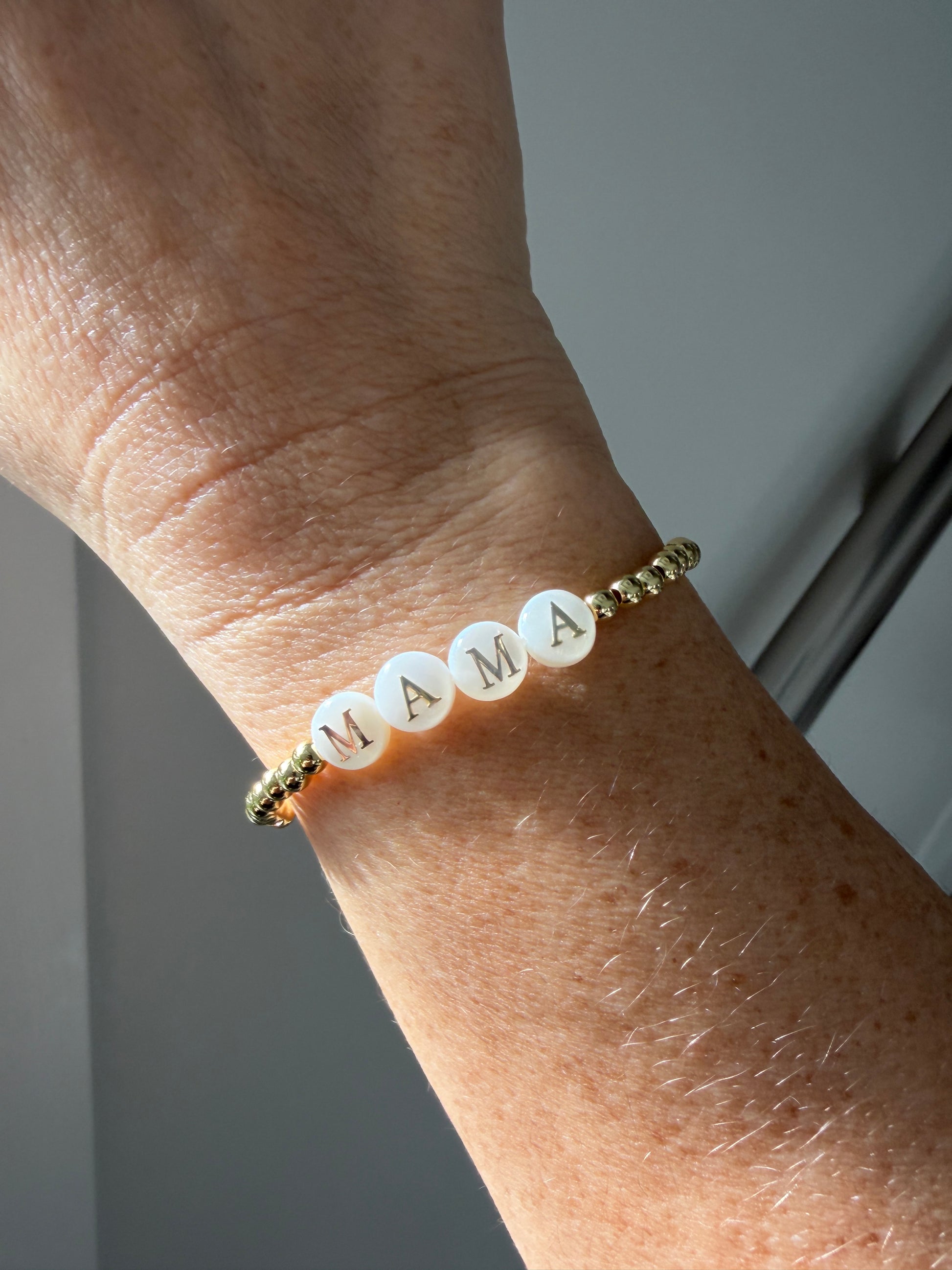 18k Gold-filled mama bracelet stacked with minimalist gold bracelets