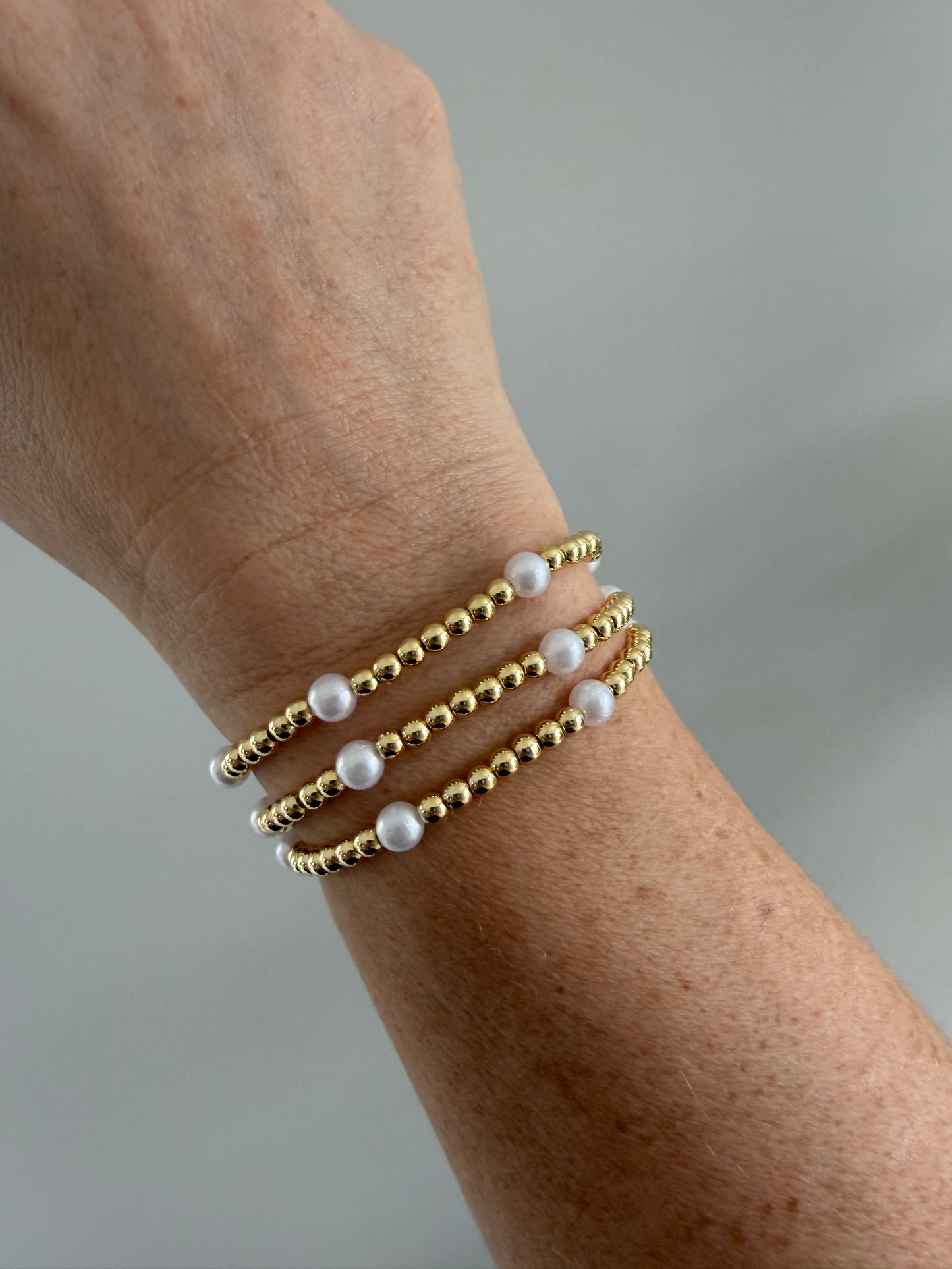 Gold-filled pearl beaded bracelet worn alone on wrist