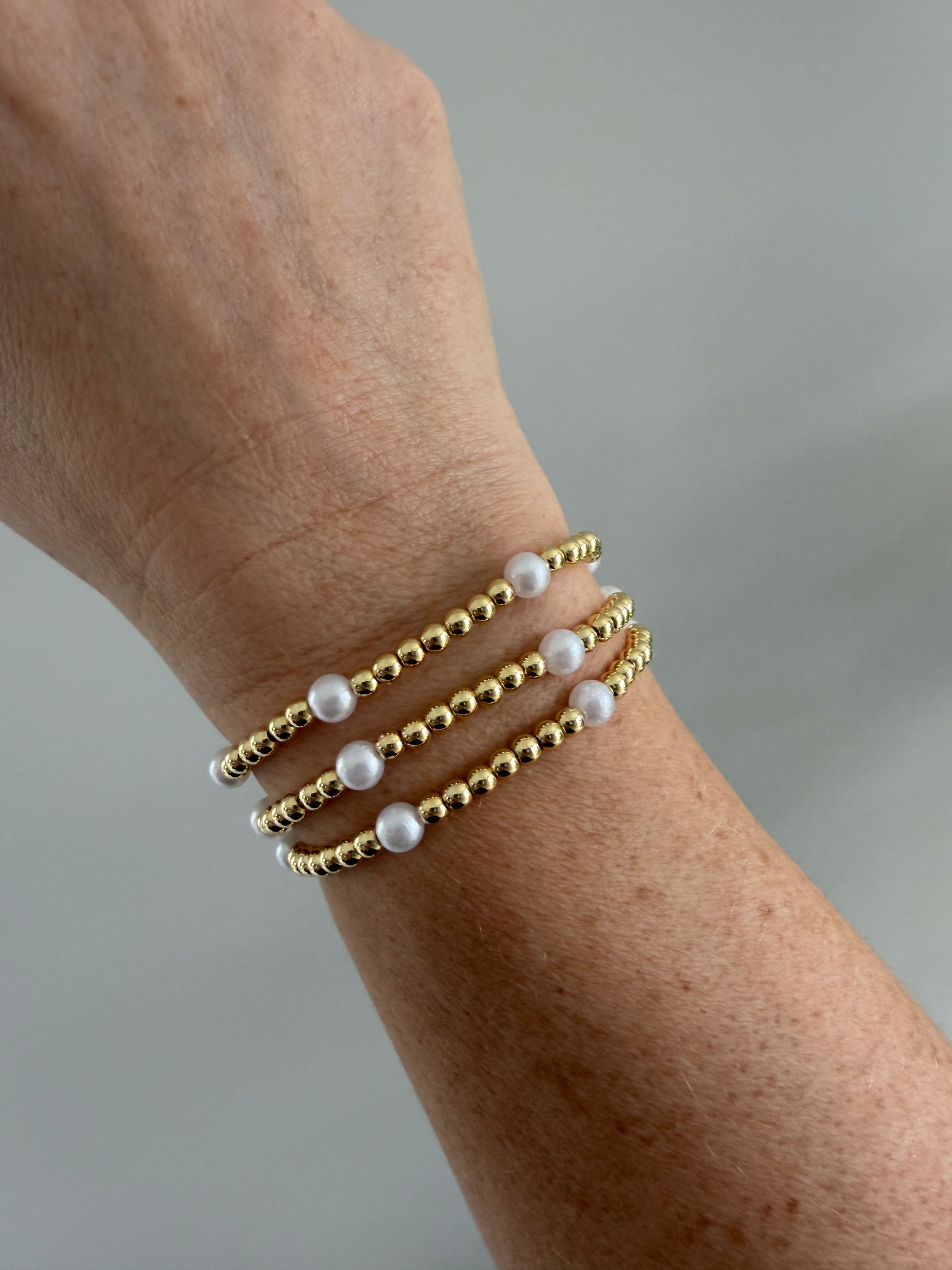 Gold-filled pearl beaded bracelet worn alone on wrist