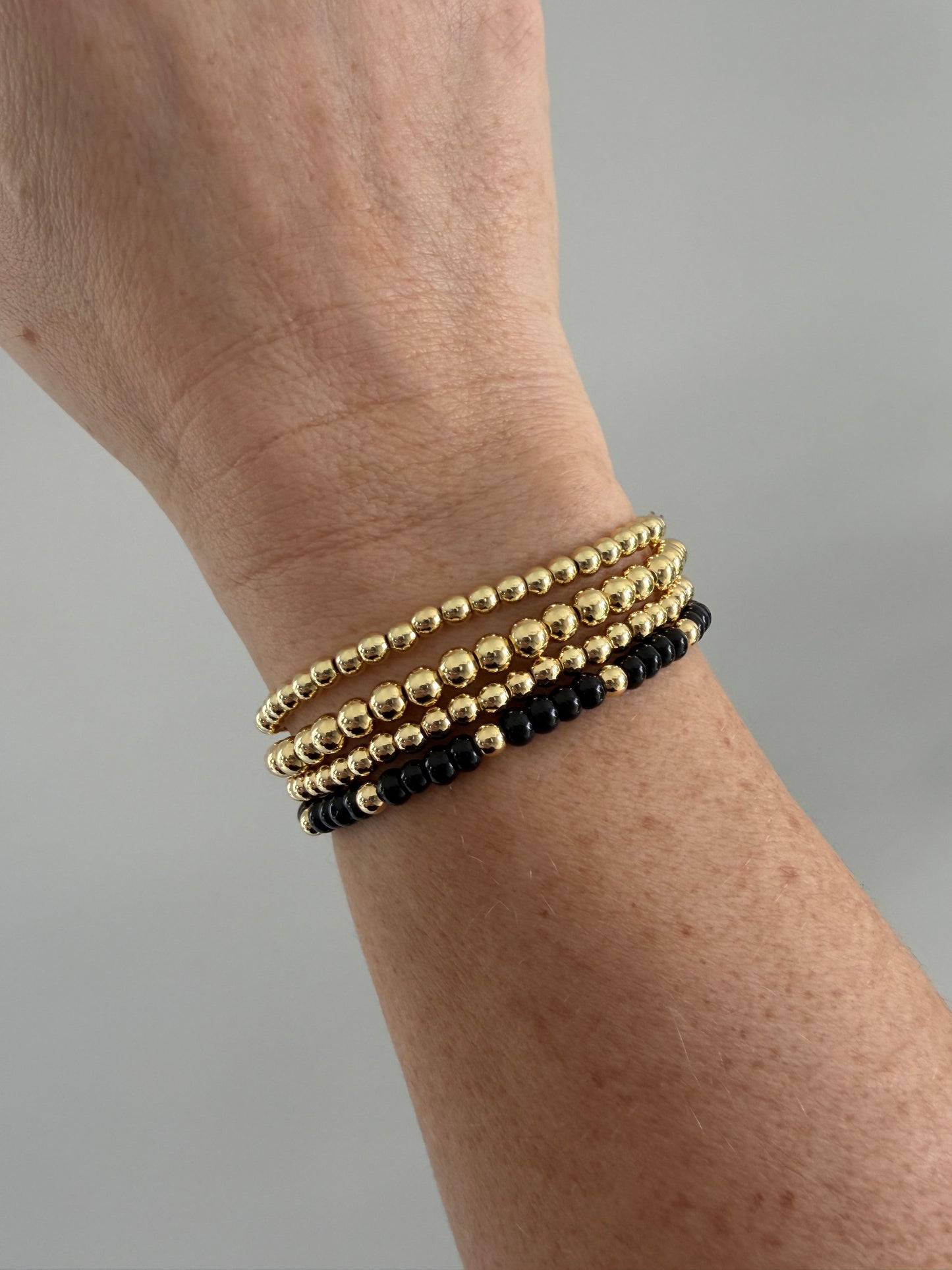 18K gold-filled beaded bracelet with black bead accents