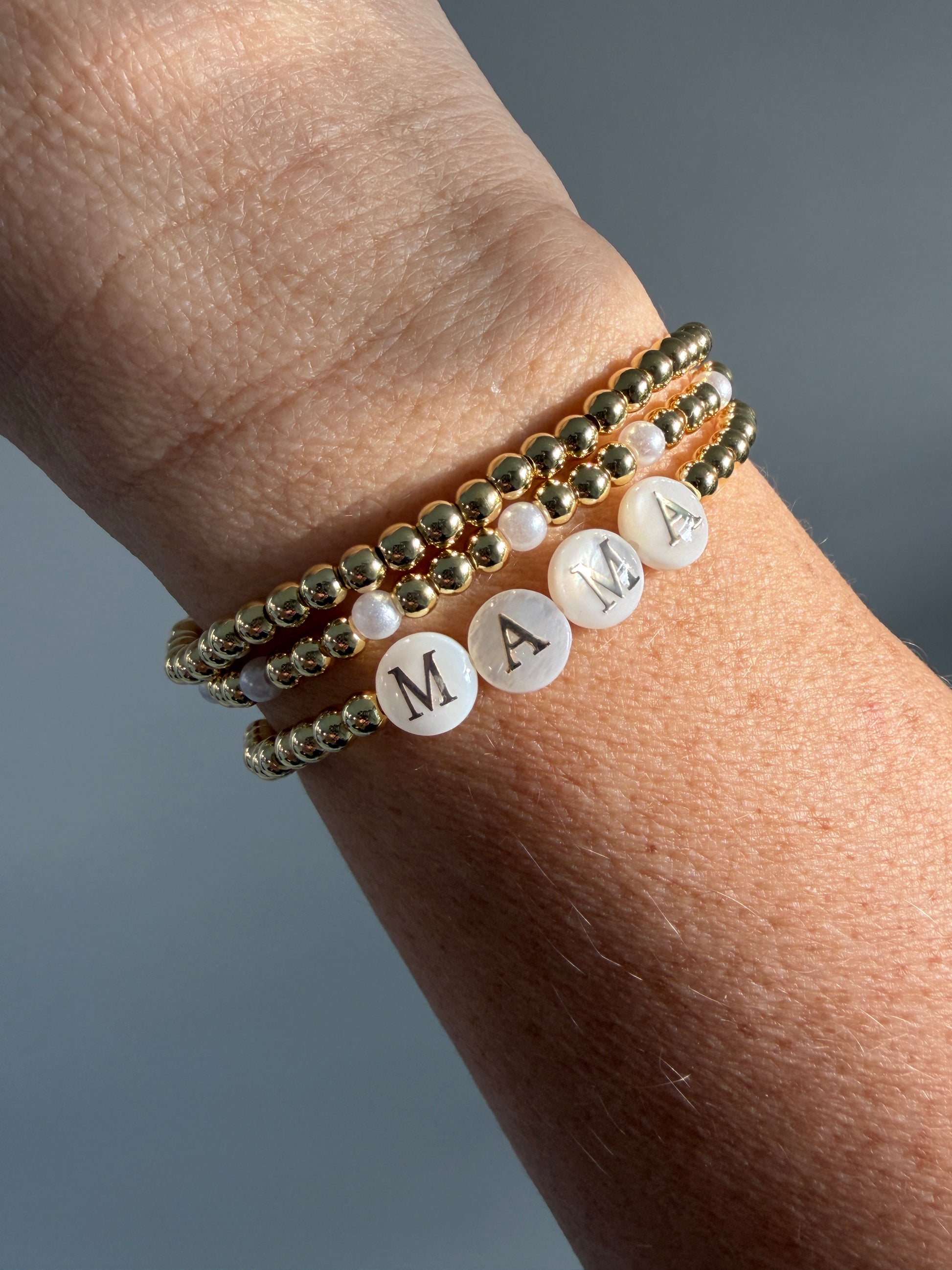 Gold-filled beaded bracelet with pearls stacked with minimalist gold jewelry