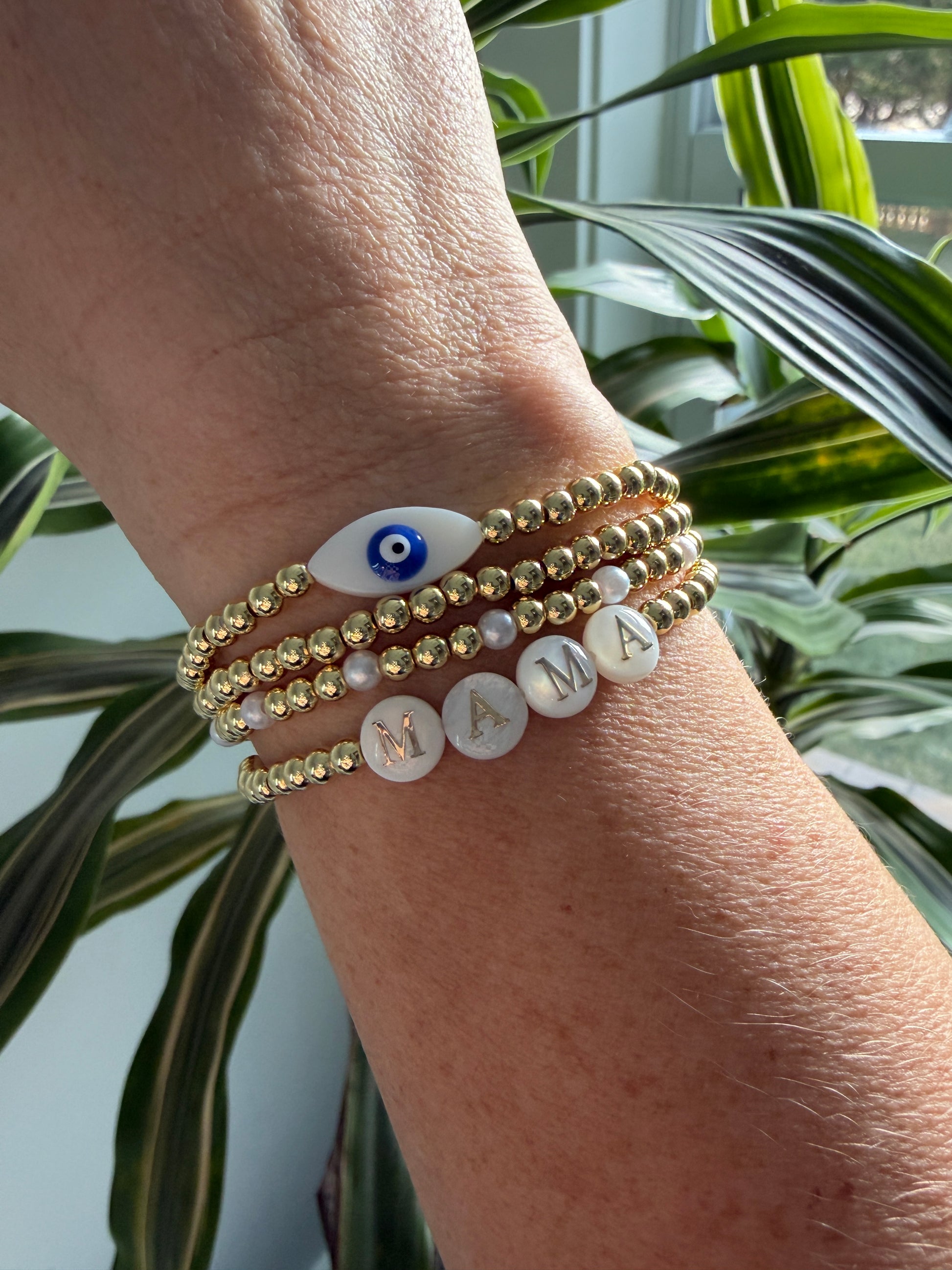 Gold-filled beaded bracelet with pearls stacked with minimalist gold jewelry