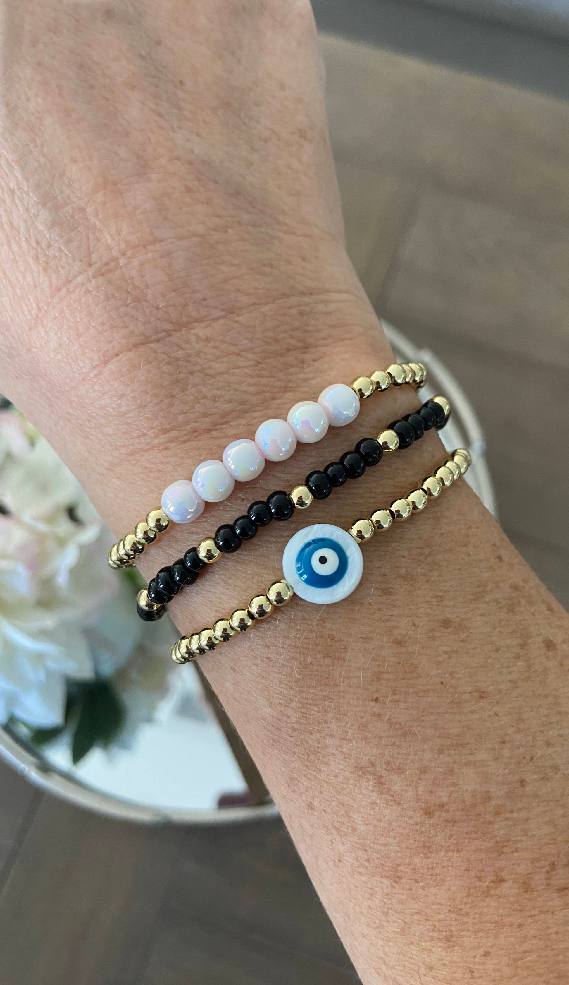 Gold-filled beaded bracelet with pearls stacked with minimalist gold jewelry